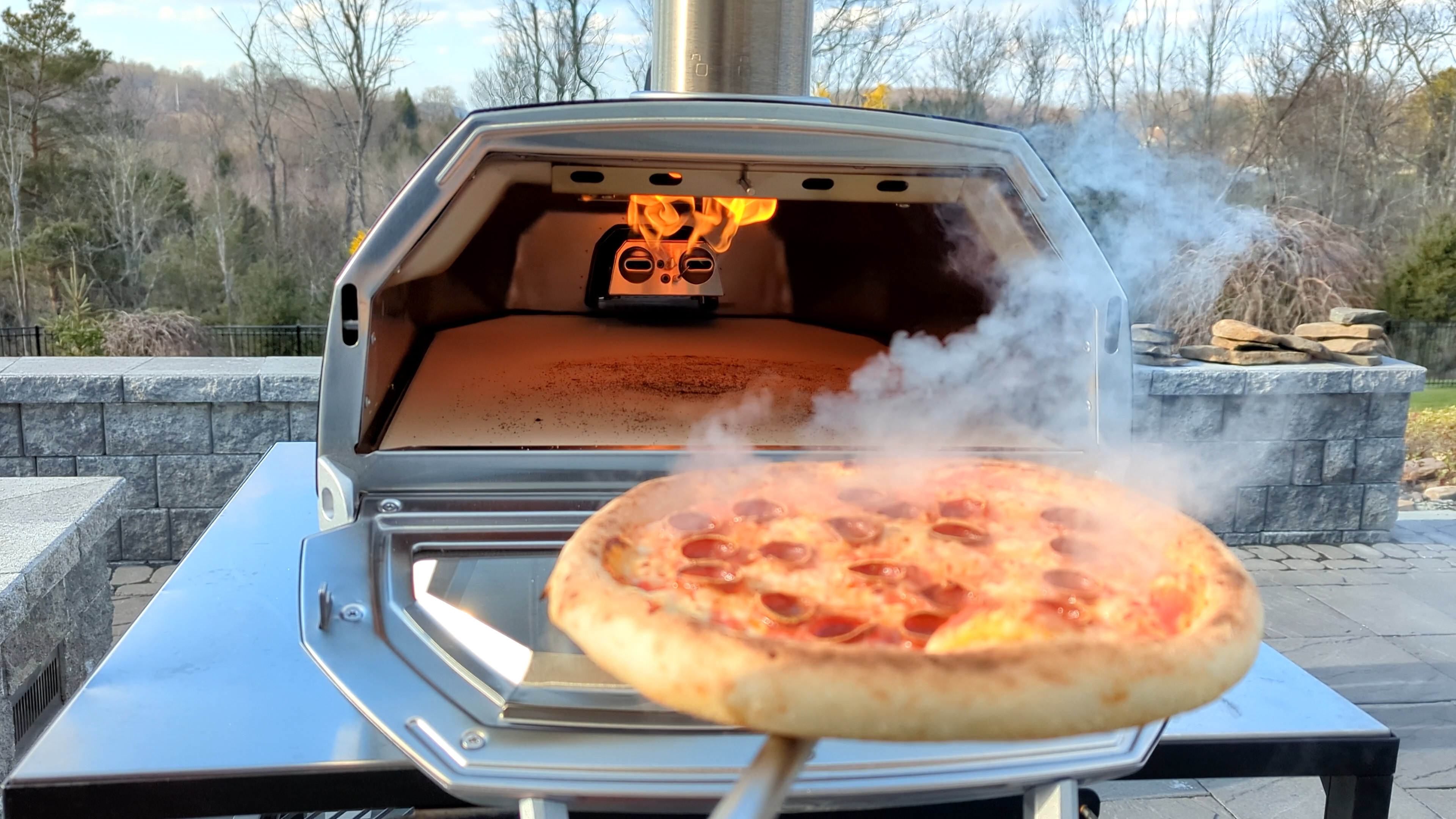 Pizza cooking in an active Ooni Karu 16 pizza oven