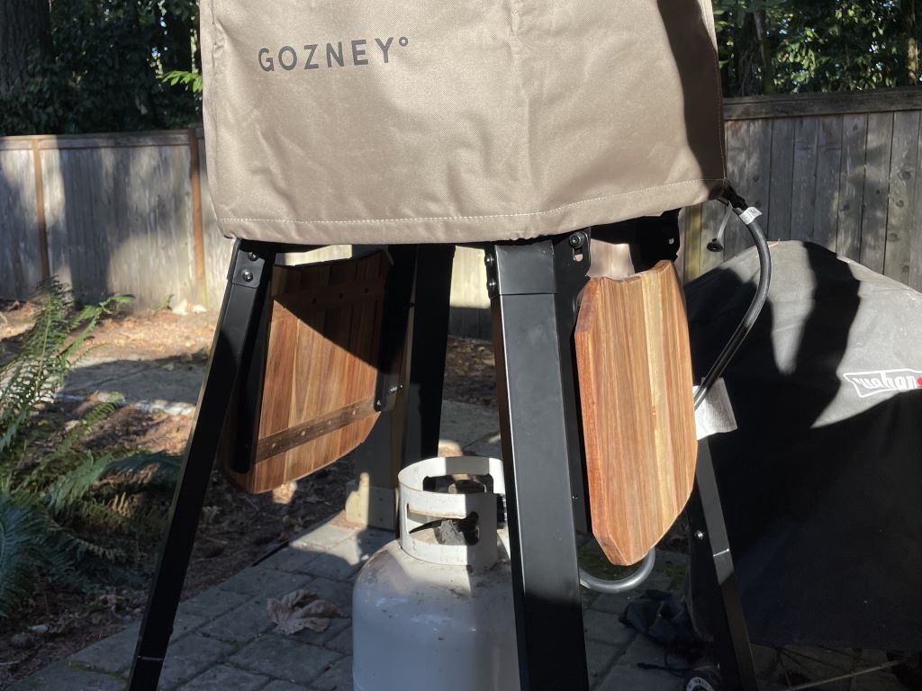 The Arc XL pizza oven on its optional stand with the cover on it for storage.