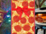 A collage showing a pizza slice Christmas ornament on a tree on the left, the surface of a pepperoni pizza with a red bow in the middle, and a pizza oven with the flame lit and a slice of pizza held in front on the right.