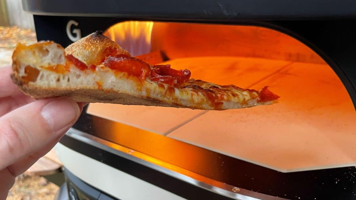 Gozney Dome Gen 2 Review - Gozney's Biggest Oven Gets Even Bigger Pizza Oven A slice of pizza in front of the Dome Gen 2.
