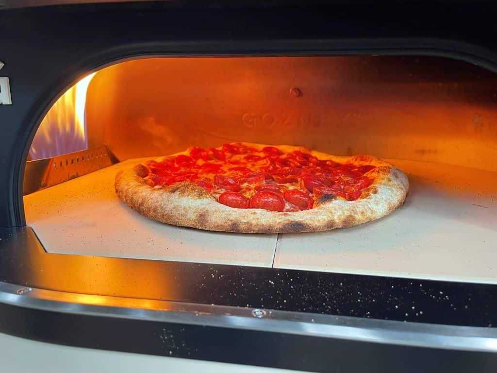 Gozney Dome Gen 2 Review - Gozney's Biggest Oven Gets Even Bigger Pizza Oven Pepperoni pizza baking outdoors in the Dome Gen 2.